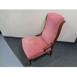 A Victorian mahogany framed nursing chair upholstered in a pink dralon