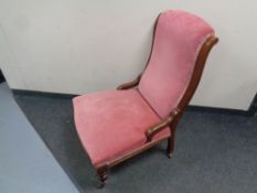 A Victorian mahogany framed nursing chair upholstered in a pink dralon