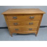 An Edwardian oak three drawer chest