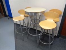 A circular poser bar table on metal legs together with a set of four bar chairs on metal legs