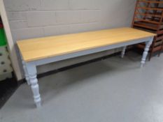 A pine topped refectory dining tables on painted bases, length 240 cm,