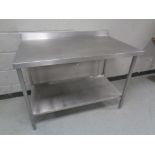 A stainless steel commercial two tier food preparation table, width 114 cm, depth 70 cm,