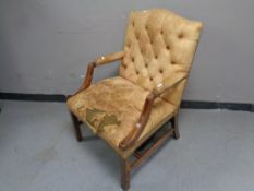 A 20th century mahogany framed Gainsborough style armchair upholstered in brown buttoned leather