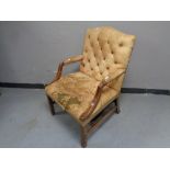 A 20th century mahogany framed Gainsborough style armchair upholstered in brown buttoned leather