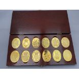 A boxed set of twelve silver gilt Arms of the Prince and Princess of Wales coins
