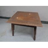 A heavily carved eastern occasional table,