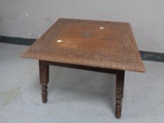 A heavily carved eastern occasional table,