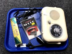 A tray containing a radio together with a guitar tuner,