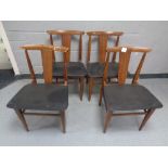 A set of four mid 20th century teak dining chairs