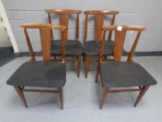 A set of four mid 20th century teak dining chairs