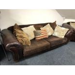 A Tetrad leather and fabric settee with scatter cushions