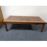 A 20th century teak effect coffee table with an inset panel,