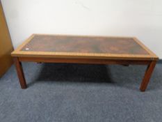 A 20th century teak effect coffee table with an inset panel,