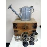 A wooden storage box and metal wares to include galvanised watering can, candlesticks,