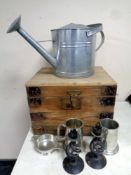 A wooden storage box and metal wares to include galvanised watering can, candlesticks,