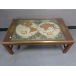 A brass bound glass topped coffee table depicting a map of the world