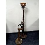 A wooden oil lamp stand together with a further wooden stand