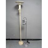 A painted cast iron standard lamp (as found) together with an angle poise floor lamp