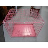 A folding metal dog cage