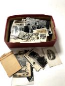 A box containing a quantity of monochrome photographs and postcards