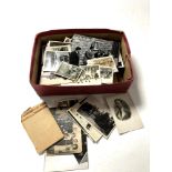 A box containing a quantity of monochrome photographs and postcards