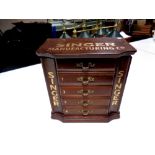 A table top jewellery chest bearing Singer advertisement