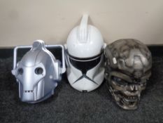A Doctor Who cyberman mask together with a Star Wars mask and one further mask