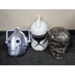 A Doctor Who cyberman mask together with a Star Wars mask and one further mask