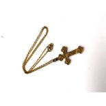 A 9ct gold crucifix pendant on yellow metal chain,