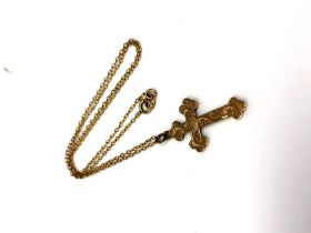 A 9ct gold crucifix pendant on yellow metal chain,