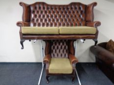 A brown button leather Chesterfield wingback settee with matching armchair