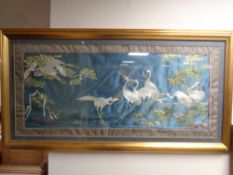 An oriental silk needlework panel depicting herons in gilt frame