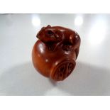 A carved Chinese hardwood netsuke,