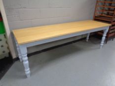 A pine topped refectory dining tables on painted bases, length 240 cm,