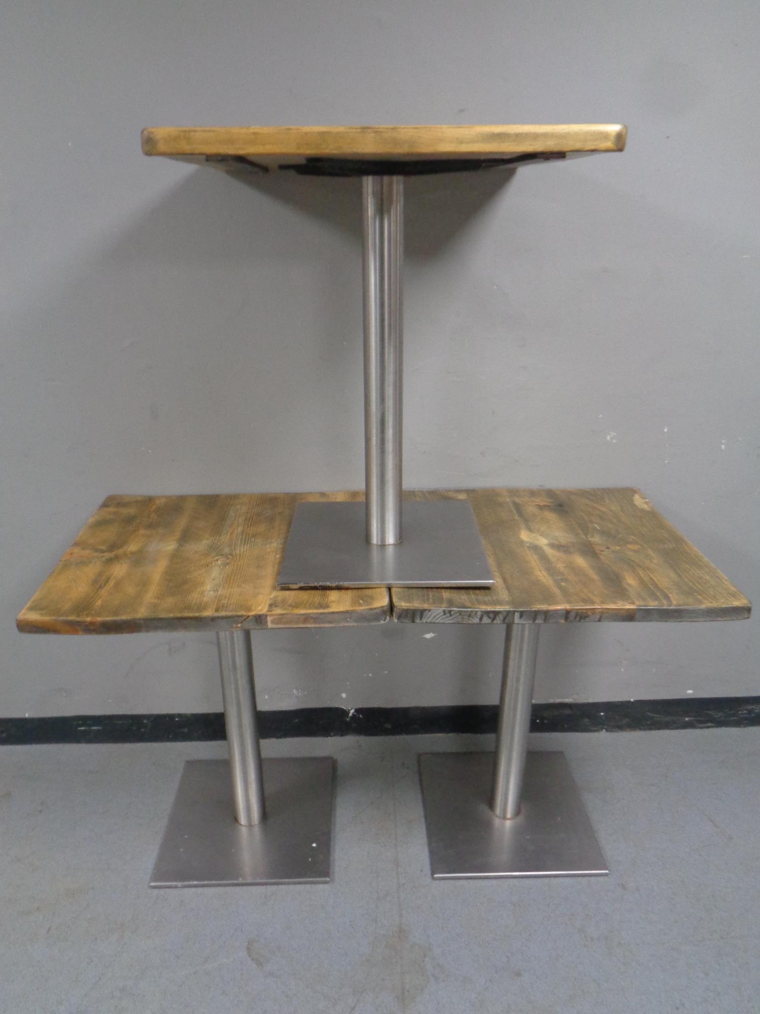 A set of three pine topped metal based cafe tables