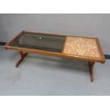 A 20th century G Plan teak refectory coffee table with a smoked glass inset panel and a tiled inset
