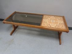 A 20th century G Plan teak refectory coffee table with a smoked glass inset panel and a tiled inset