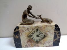 A marble Art Deco mantel clock surmounted by female figure with deer