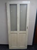 An antique painted pine interior door with two glass etched inset panels