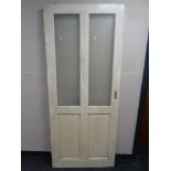 An antique painted pine interior door with two glass etched inset panels