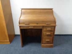 A reproduction oak roll top desk