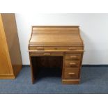 A reproduction oak roll top desk