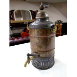 An antique copper and brass tea urn