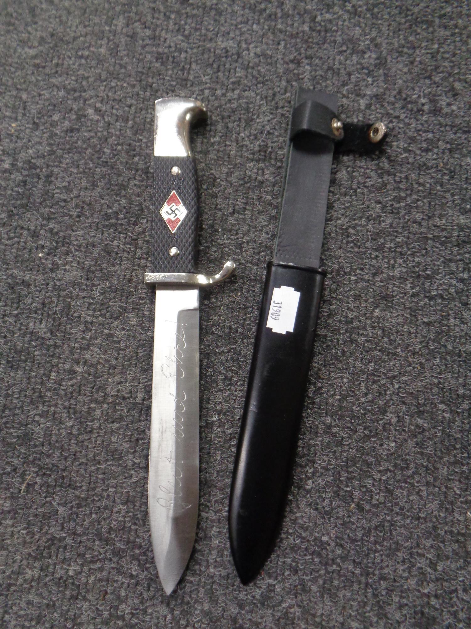 A reproduction German dagger in sheath