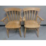 A pair of pine kitchen armchairs