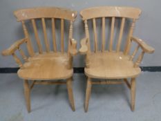 A pair of pine kitchen armchairs