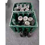 Two plastic brewery crates containing twelve vintage green glass wine bottles