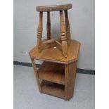 An Edwardian oak octagonal three tier book table together with an antique pine farmhouse stool