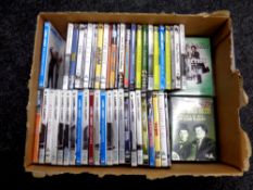 A box containing a large quantity of Laurel and Hardy DVDs