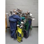 Ten golf bags containing a large quantity of assorted adult's and children's drivers,